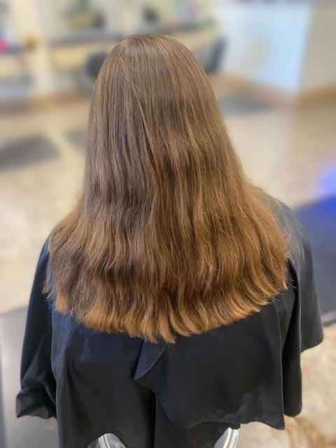Women's cut styled with smooth volume.