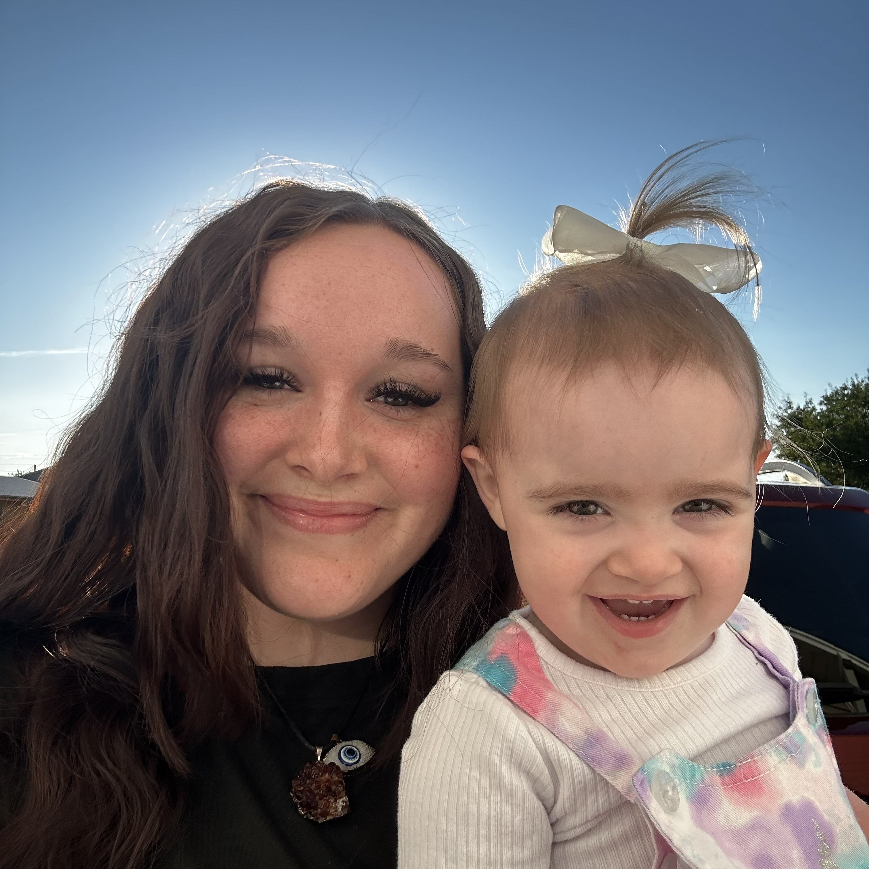 Portrait of Zoey, smiling barber ready to cut hair.